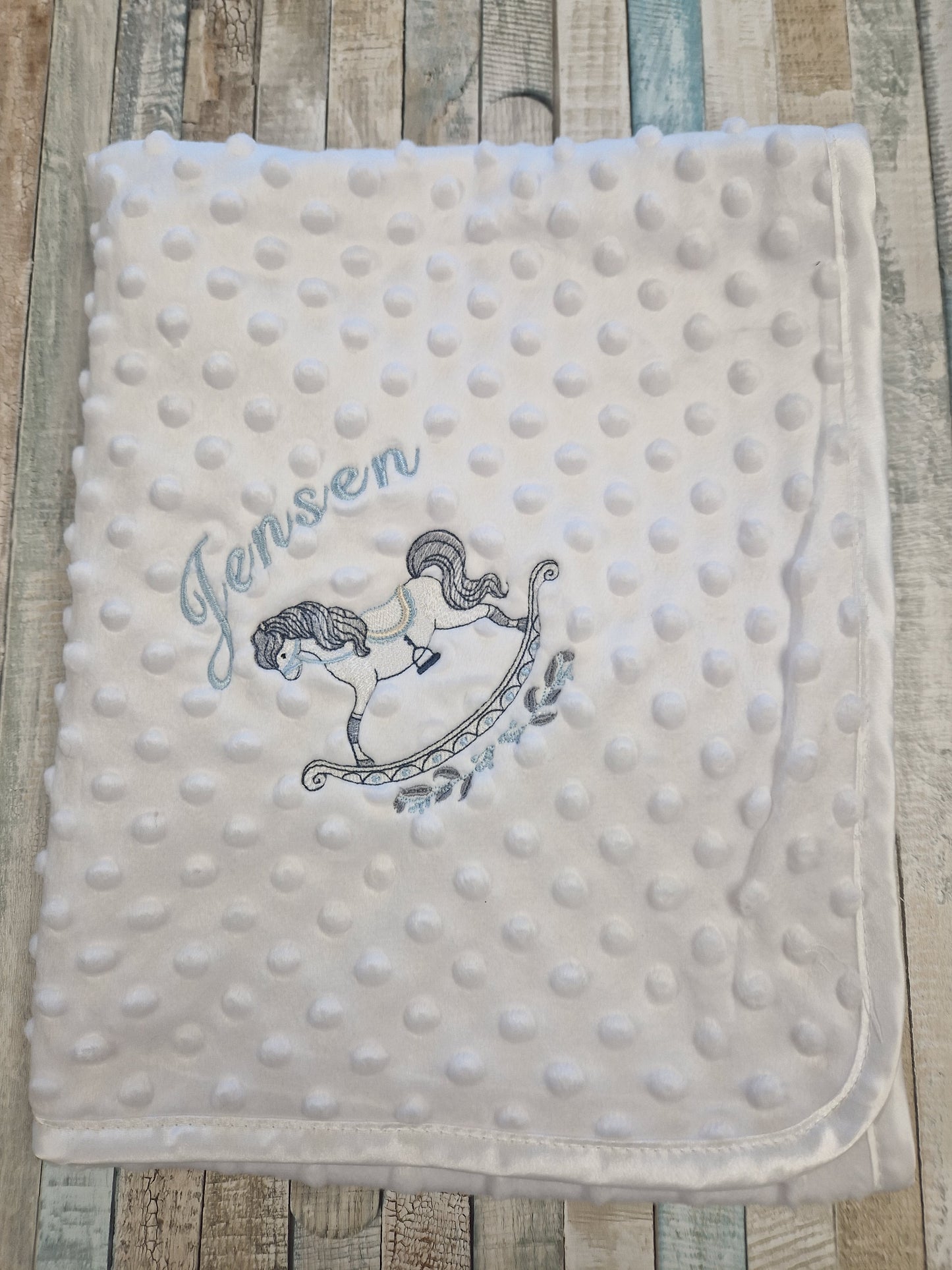 Personalised White Soft Dimple Wrap With Blue Rocking Horse Design