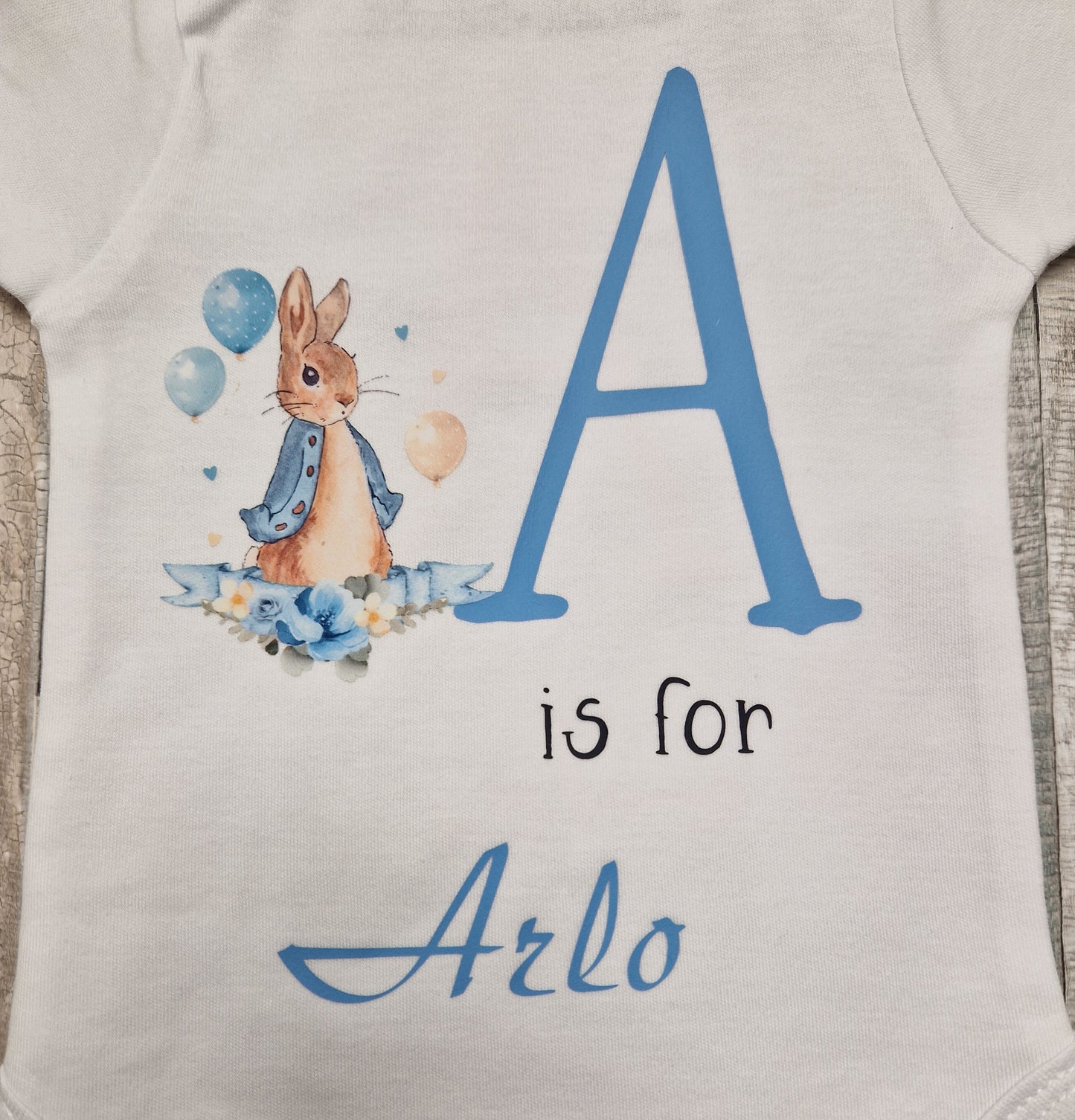 Personalised White Babygro With Printed Blue Rabbit Initial And Name