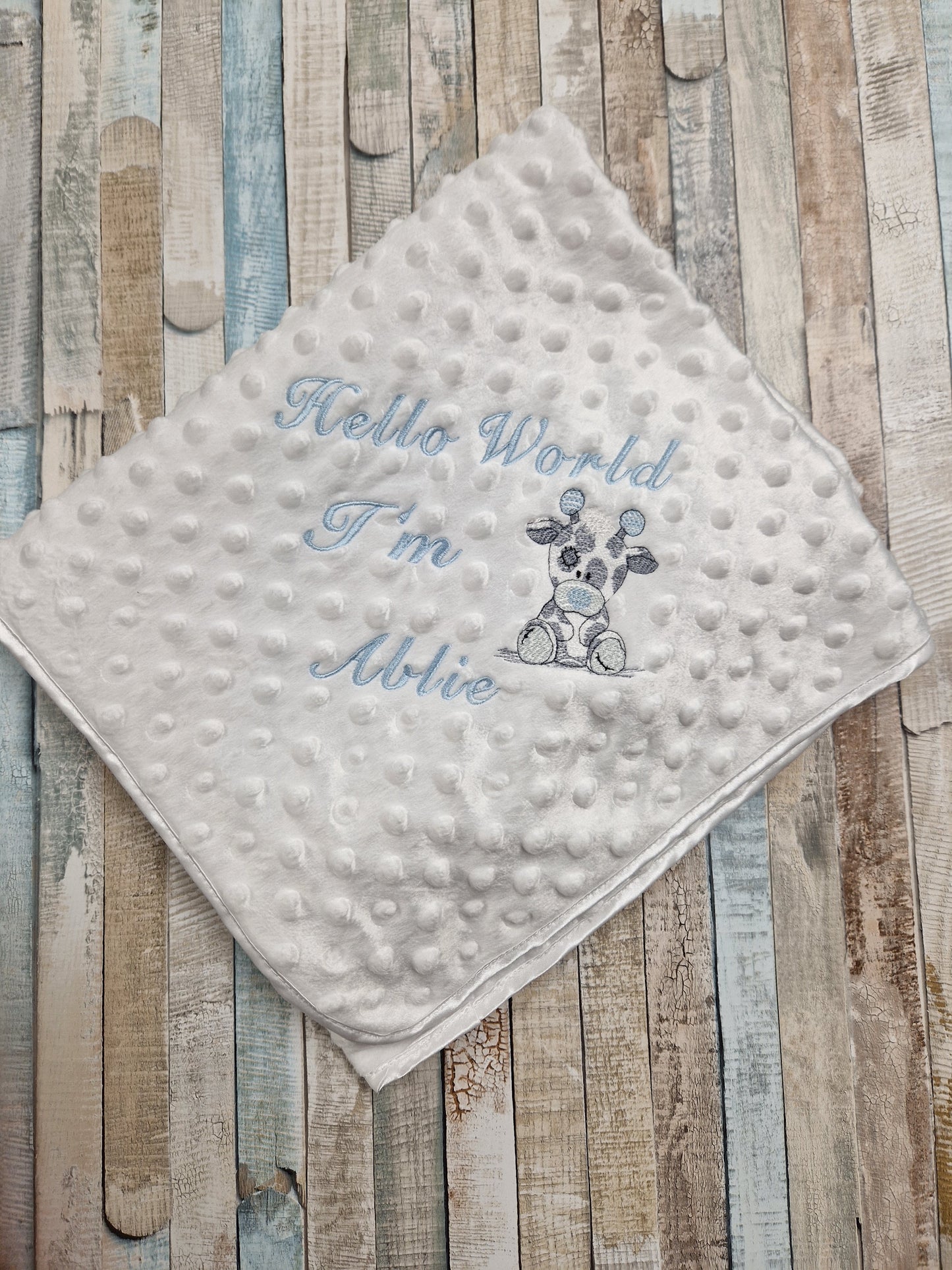 Personalised Hello World White Dimple Wrap With Blue Giraffe Embroidered Design