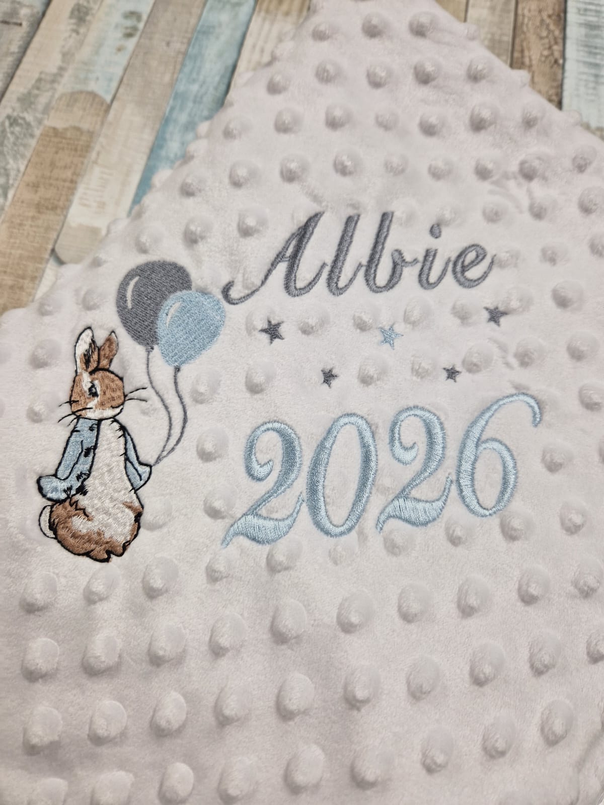 Personalised Baby Boys White Dimple Wrap With Blue Rabbit And Balloons And Year Of Birth