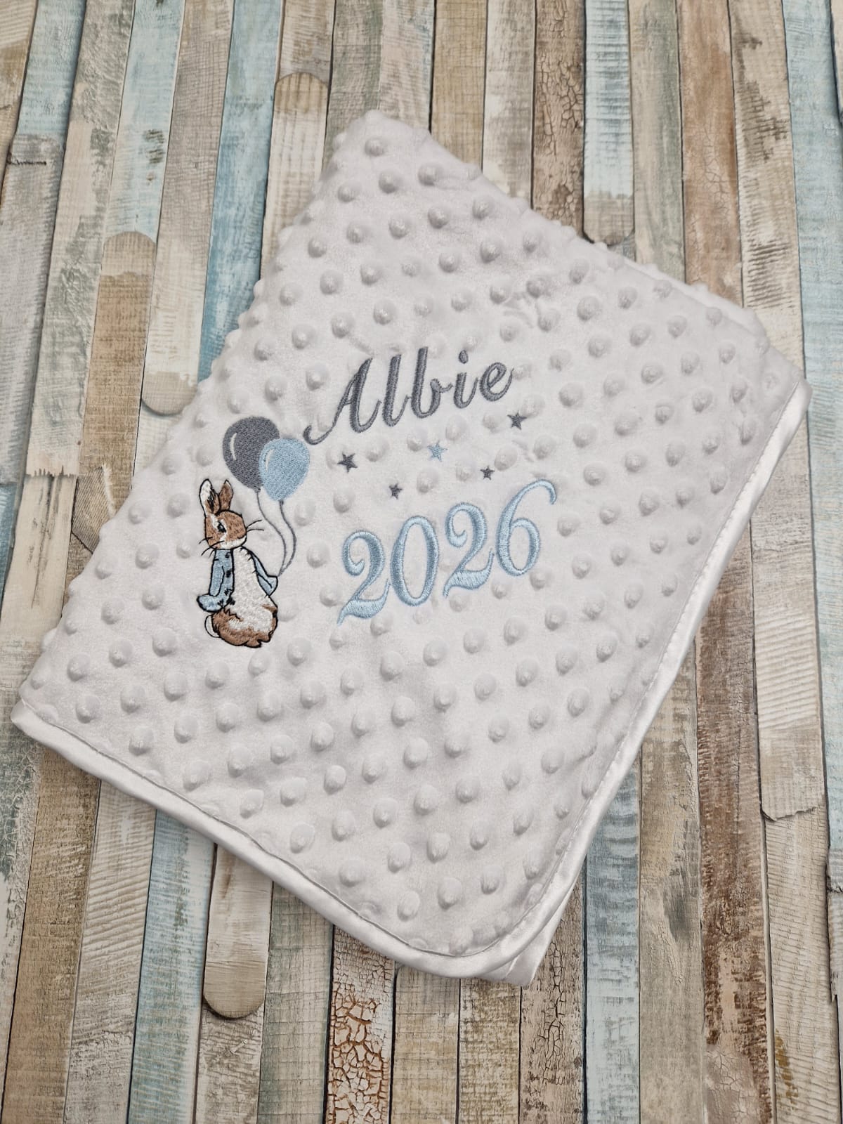 Personalised Baby Boys White Dimple Wrap With Blue Rabbit And Balloons And Year Of Birth